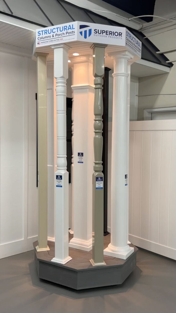 A Superior Outdoor Products showroom sample stand featuring varying white structural posts for decks.